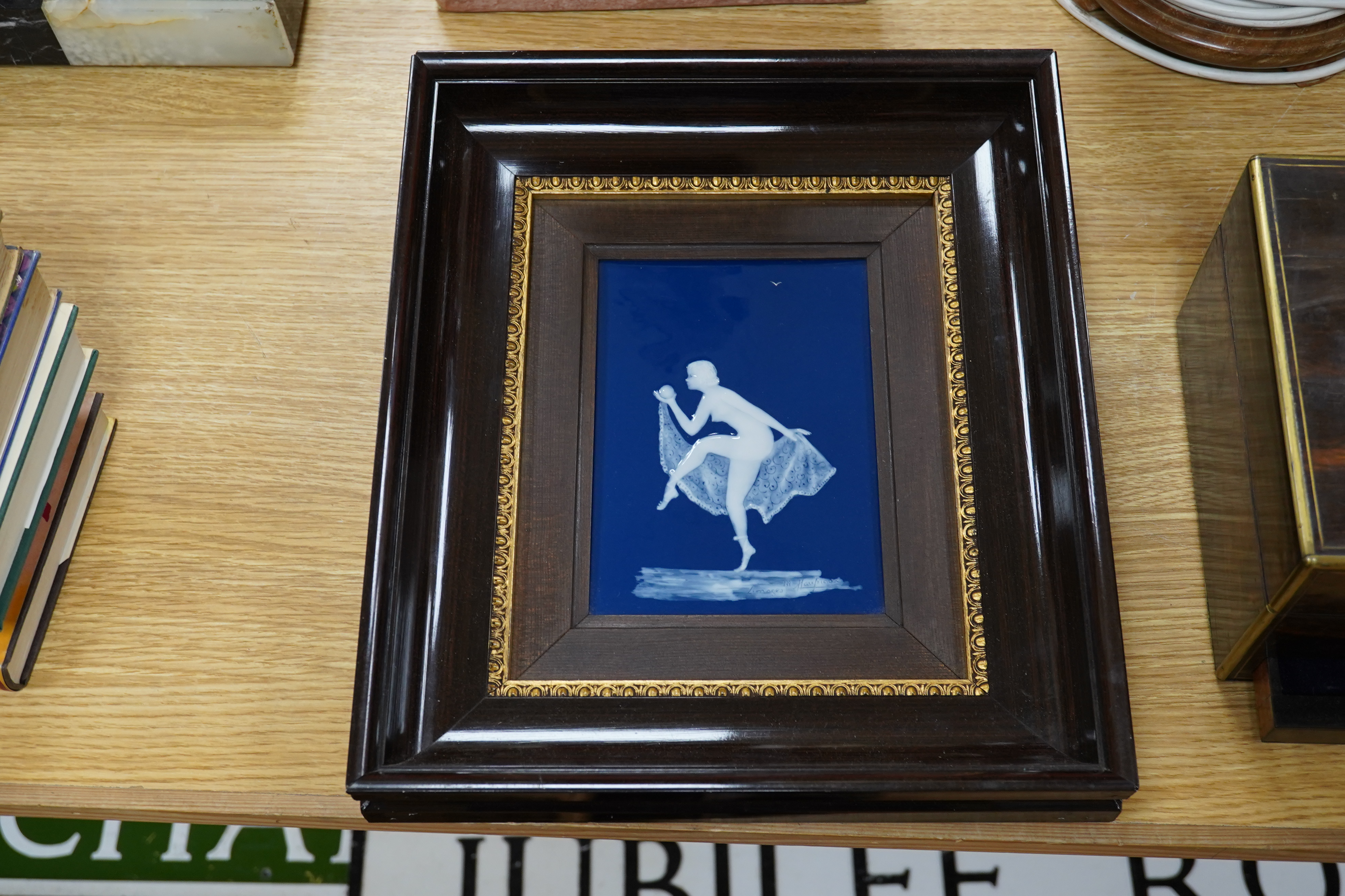 A 20th century framed Limoges blue and white pate-sur-pate plaque, of a female dancer with a ball, signed Marcel, plaque 12cm x 17.5cm. Condition -good